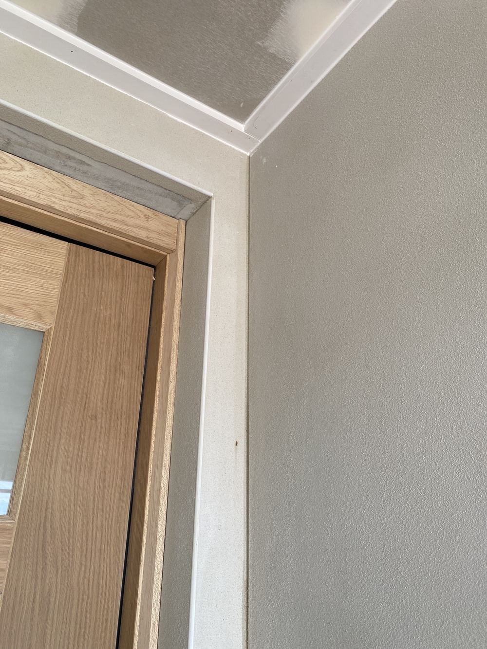 Control joint bridged by render at the front, needing a flexible sealant instead, found during a fixing inspection in Gables