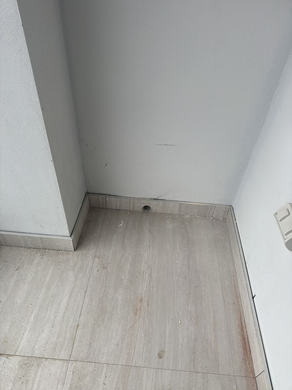Balcony membrane not terminated into the overflow outlet as required, found during a handover inspection in Gables