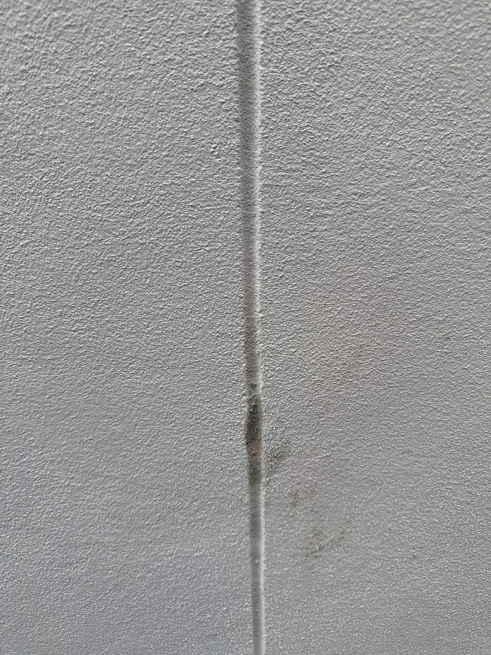 Control joint rendered over, needing the render cut back and the joint sealed, found during a handover inspection in Gables
