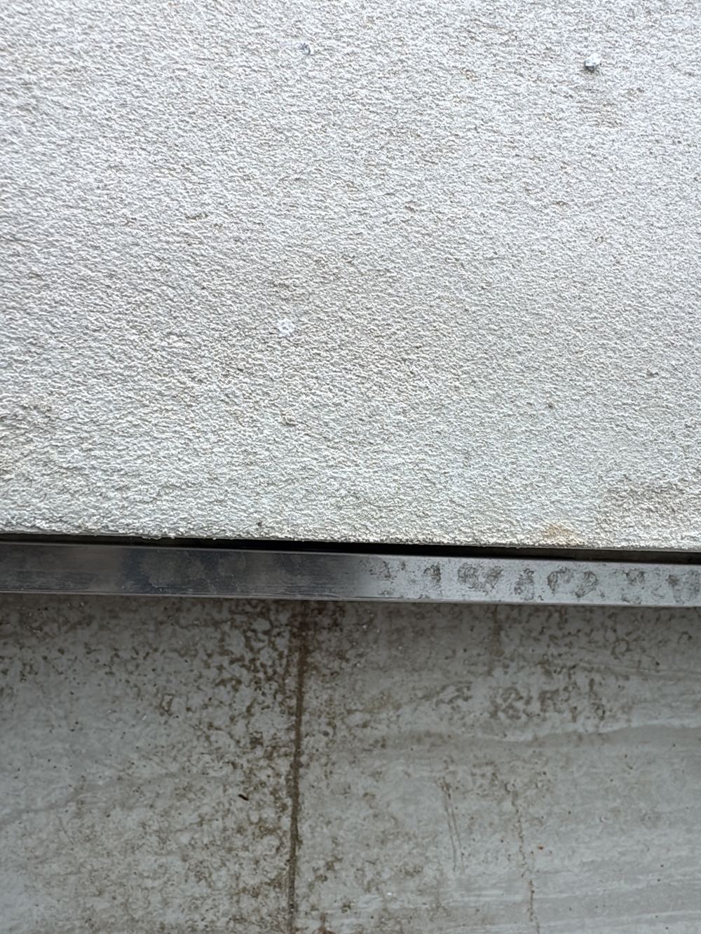 Balcony floor tiles spot-fixed rather than fully bedded, so they can crack, found during a handover inspection in Gables