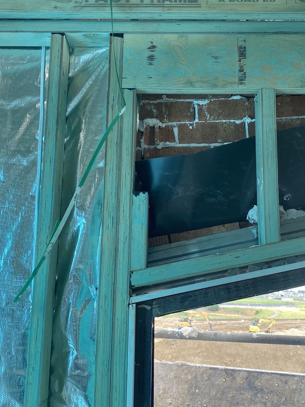 Window head flashing stopping short of the 150mm it should run past each side, found during a lock-up inspection in Gables