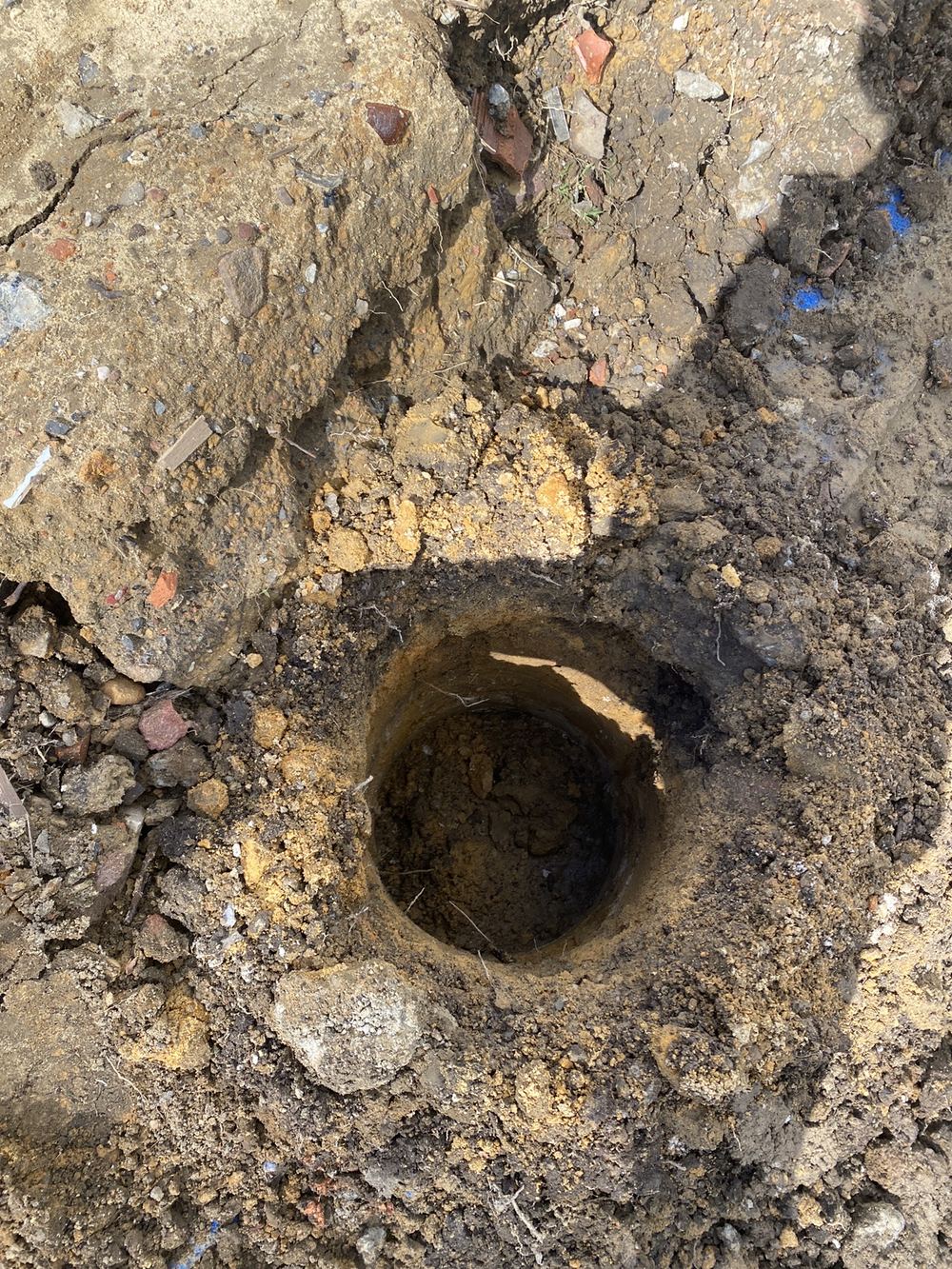 Pier hole still needing its base cleared down to firm ground, found during a bored pier inspection in Epping