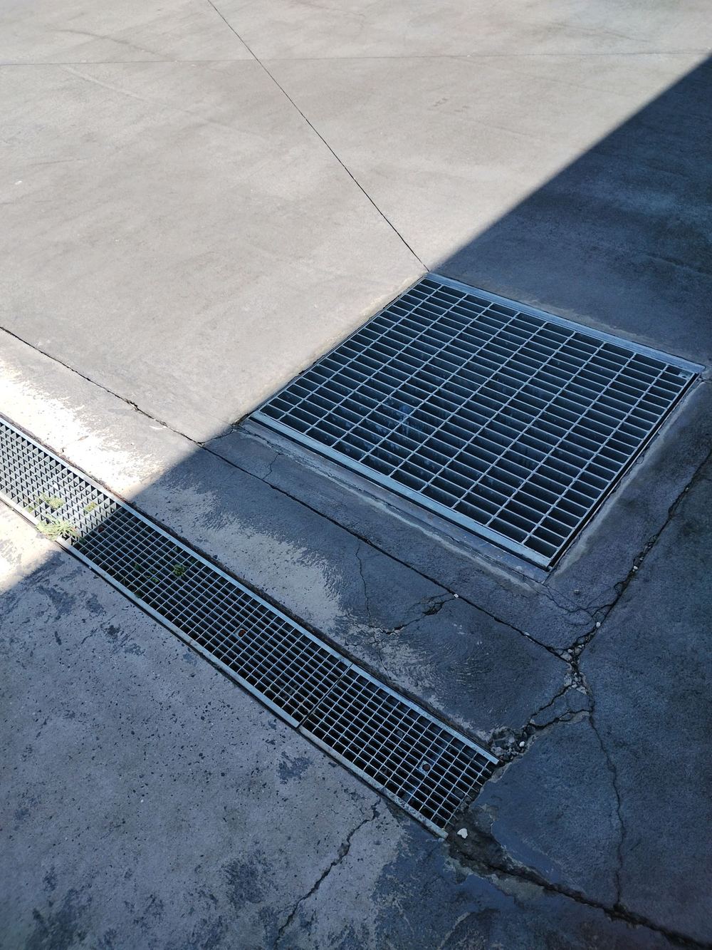 Major cracking through outdoor concrete beside a drainage grate, found during a pre-purchase inspection in Blacktown
