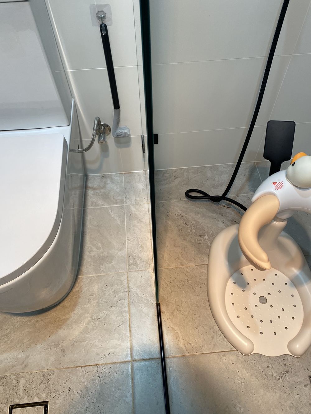 Open shower with no hob or step-down to hold water back, found during a pre-purchase inspection in Carlingford