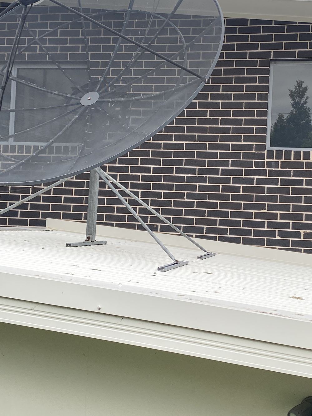 No weep holes where a lower roof meets the brick wall, found during a pre-purchase inspection in Carlingford