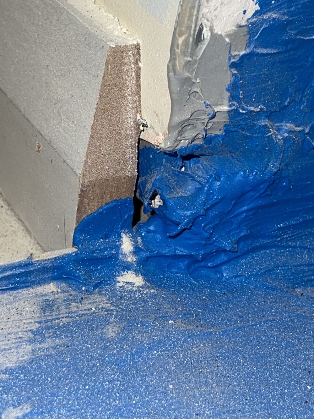 Membrane broken at a wet area junction, found ahead of the tiler, found during a waterproofing inspection in Gables