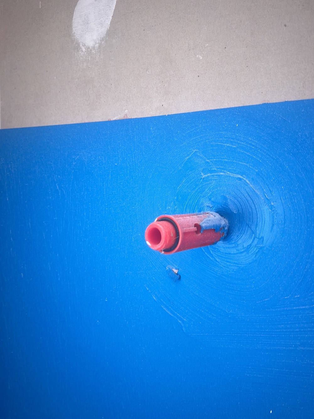 Damaged membrane around a shower outlet, recorded before tiling started, found during a waterproofing inspection in Gables